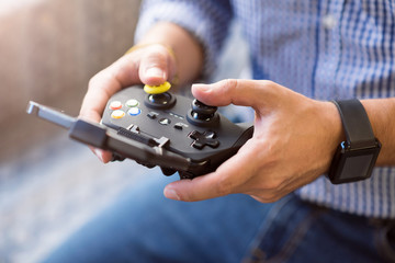 Pleasant man holding game console