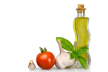 Olive oil and fresh vegetables isolated on white