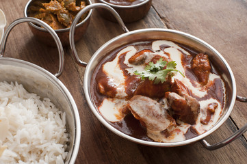 Creamy sauce on cooked chicken with rice on table