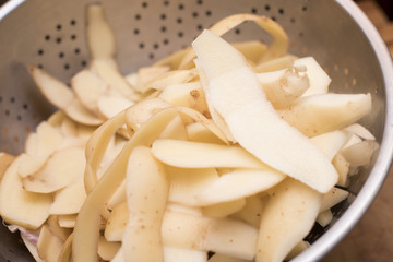 Potato peelings in a metal colander