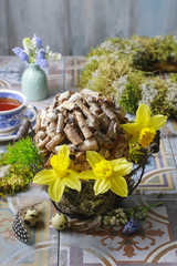Floral arrangements with daffodils and pieces of wood.