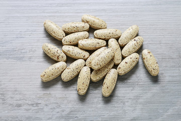 Stack of pills on wood