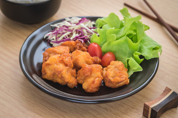 Fried chicken with vegetables on plate and rice in bowl, Japanese style