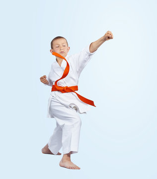 Boy in karategi beats punch arm