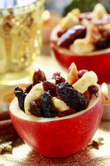 Red christmas apples stuffed with dried fruits in honey