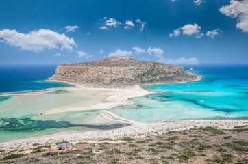 Balos lagoon on Crete island, Greece. Tourists relax and bath in crystal clear water of Balos beach.