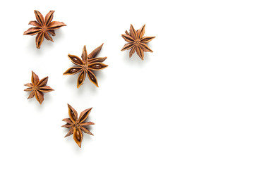 Star anise, scattered in a chaotic manner, isolated on white background