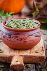 organic pumpkin seeds in a clay bowl