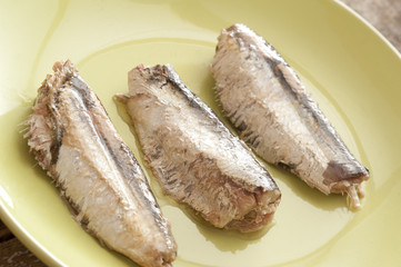 sardine pieces on a green plate