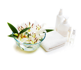 Spa sitting lily with massage oil and towel