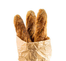 Paper packet with home baked baguettes on white.