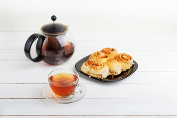 Tea and pastry on white wooden table