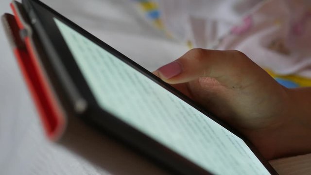 Close up view of a female hand holding e-reader