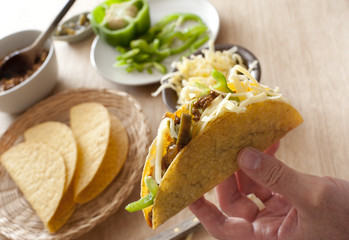 Man preparing a ground beef taco