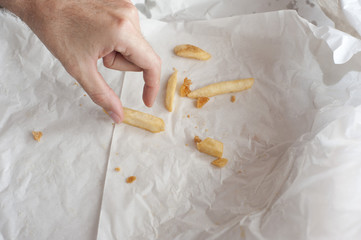 Man eating takeaway French fries