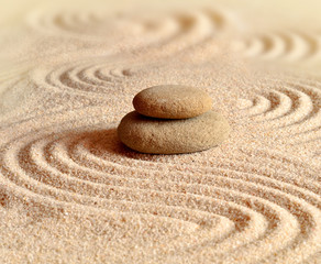stones on the sand with circles