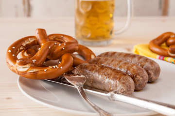 Closeup of bavarian cooked sausage and pretzel