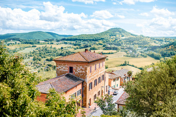 Fototapeta na wymiar Beautiful landscape view on the meadow with old buildings in Montepulciano town in Italy