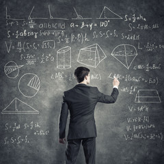 Man writing on blackboard