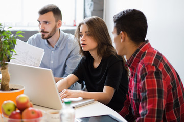 Real executives discussing new business plans, projects and strategies. Picture of busy business people working with documents in office.