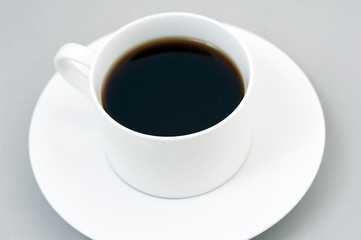Cup of black coffee on saucer