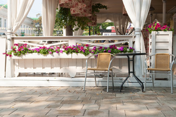 Empty tables and chairs on restaurant or cafe