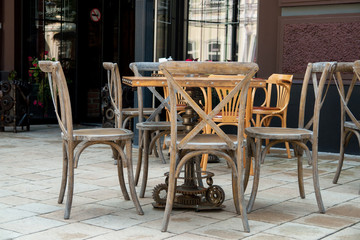 Empty tables and chairs on street cafe