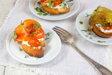 Bruschetta with cherry tomatoes, sweet pepper, mozzarella cheese and marjoram