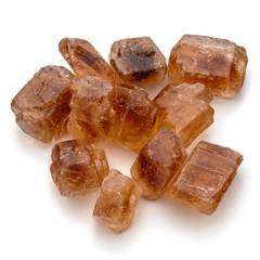 Brown caramelized lump cane sugar cube isolated on white backgro