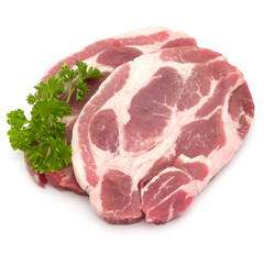 Raw pork neck chop meat with parsley herb leaves garnish isolate