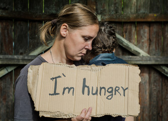 A woman with a child holding a sheet of paper. On the paper label sheet, 
