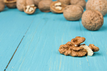 Peeled walnut closeup on blue wooden background