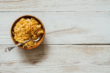 Corn flakes in wooden bowl