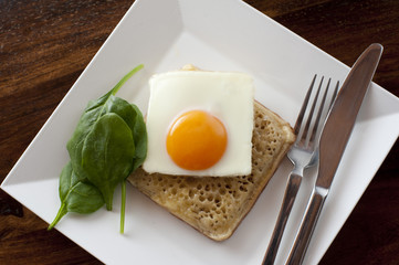 crumpet with fried egg in plate