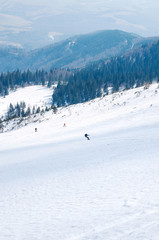 Fototapeta na wymiar man ski free ride downhill at winter season in shadow on beautiful sunny day