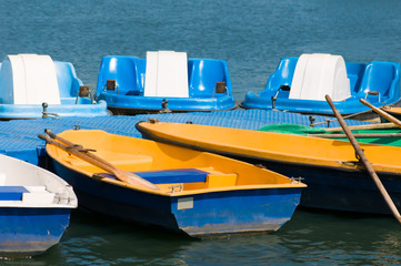 boats and catamarans are on the pier near the river in summer