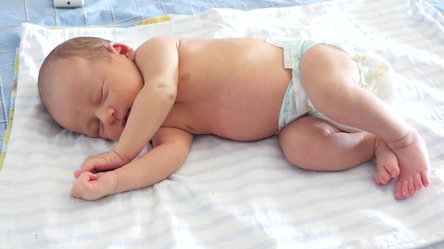 Sound sleep of an adorable newborn baby clothed in diapper