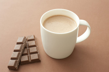White mug of cacao and milk chocolate