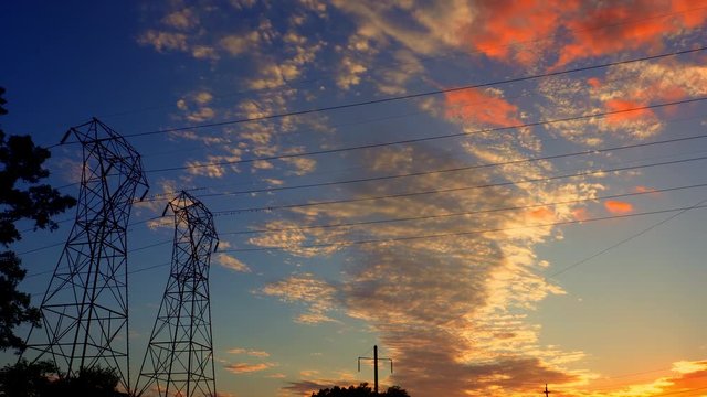 Silhouette electricity pylons in sunset background - ULTRA HD, 4k cable
