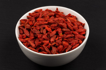 white ceramic  bowl with goji berries