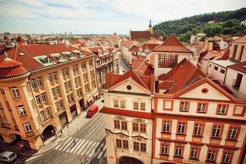 Naklejka na ściany i meble City landscape with red tiles on roofs and historical street of old Prague