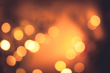 Festive warm bokeh with sparkling Christmas lights in orange colors as Christmas background