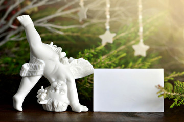 Angel figurine and Christmas card with copy space. Christmas concept
