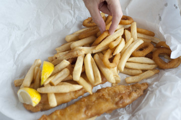 Man eating a fish and chips takeaway meal