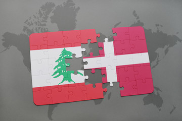 puzzle with the national flag of lebanon and denmark on a world map background.