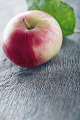 Red apple on wooden background