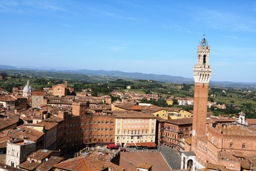 Fototapeta na wymiar View to Basilica San Francesco and Torre del Mangia in Siena, Tuscany Italy