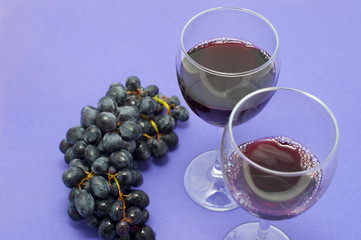 Grapes on Red Background with Wine Glasses