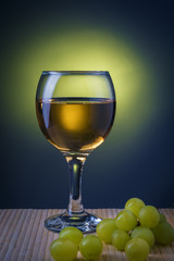 glass of white wine with grapes