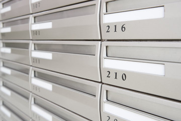 Metal letter box with room number at apartment building
